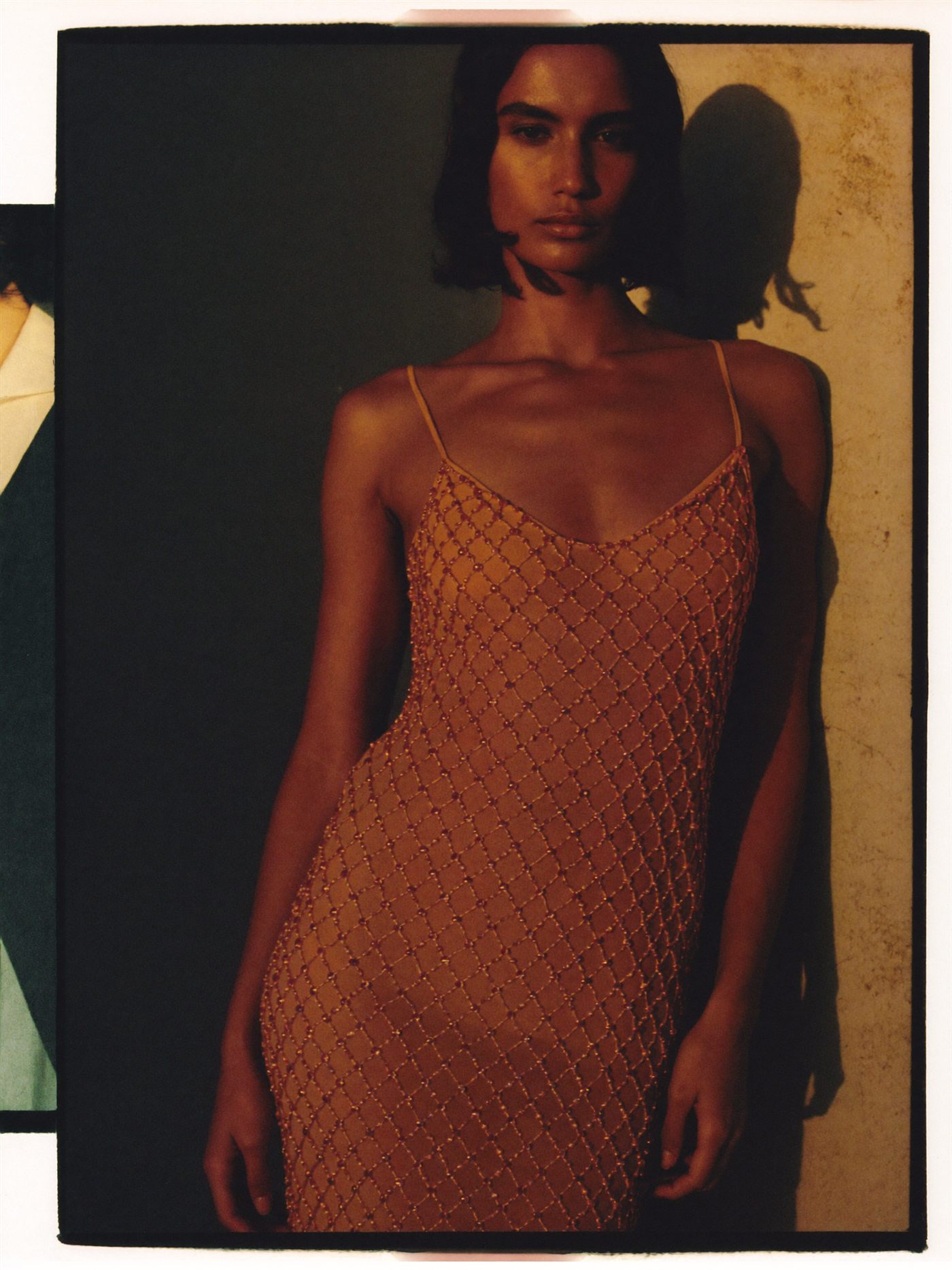Amber beaded slip dress in warm evening light
